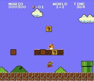 Una imagen del juego Mario Bros., en la que Mario está saltando y en el muro de arriba se ve un hongo de superpoderes